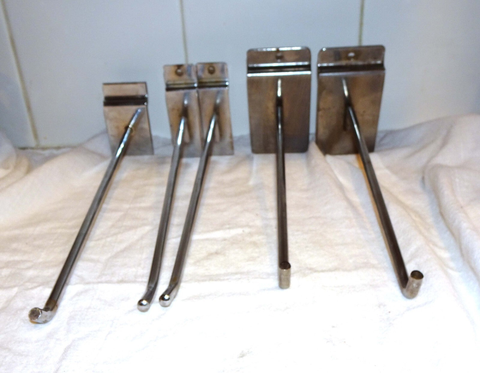 25 Used Assorted Chrome Slat wall Hangers Hooks Holder Hat Brackets Hardware