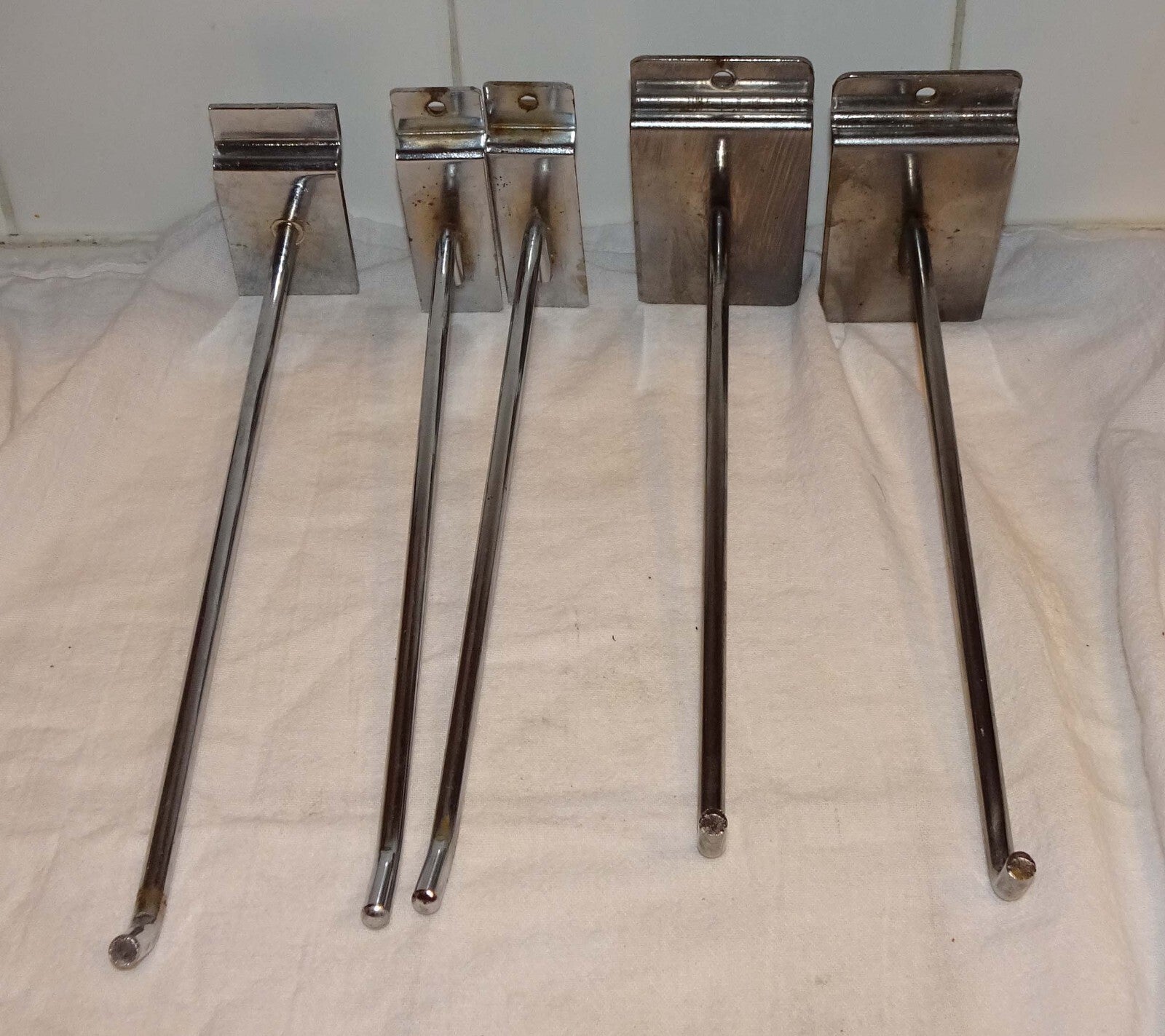 25 Used Assorted Chrome Slat wall Hangers Hooks Holder Hat Brackets Hardware