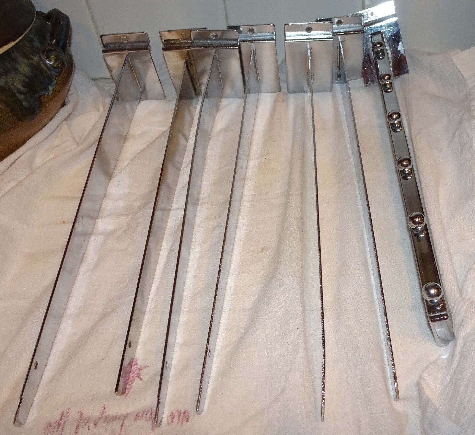 25 Used Assorted Chrome Slat wall Hangers Hooks Holder Hat Brackets Hardware